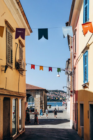 Koper, Slovenia - August 16, 2024: Picturesque street in the center of Koper with traditional...