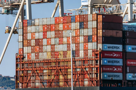 Koper, Slovenia - August 16, 2024: Cargo containers being loaded in the Port of Koper during the day