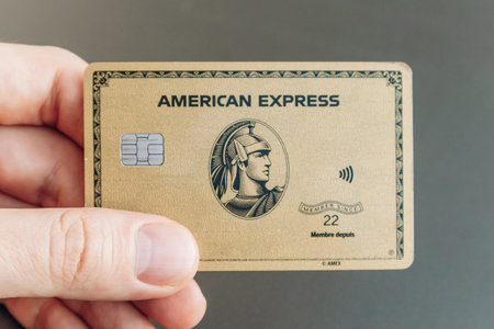Nice, France - January 5, 2025: A man's hand holding an American Express card, showcasing financial...