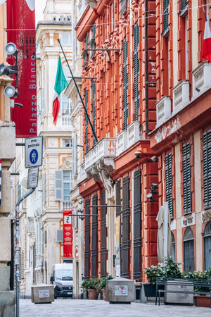 Genoa, Italy - September 22, 2024: Ornate Renaissance palaces and Italian flags line the elegant pedestrian Via Garibaldi in the historic center.のeditorial素材