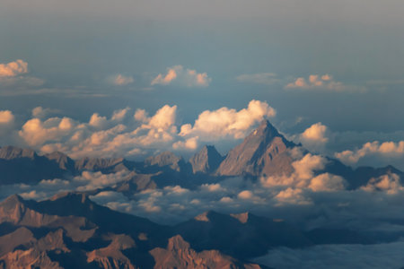 Scenic mountain landscape with clouds seen from airplane during flight from Nice to Paris