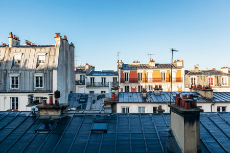 Classic Paris rooftops with chimneys and mansard windowsの写真素材