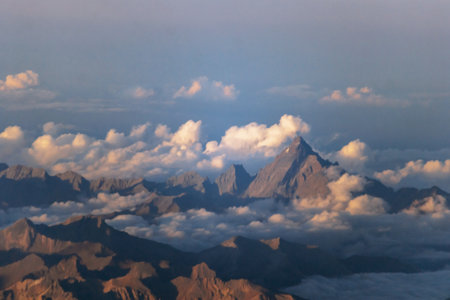 Scenic mountain landscape with clouds seen from airplane during flight from Nice to Paris