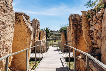 Ancient megalithic Ä gantija Temples, a UNESCO World Heritage site on XagÄ§ra plateau, featuring massive limestone blocks and original Neolithic stone architecture under a clear spring skyの写真素材