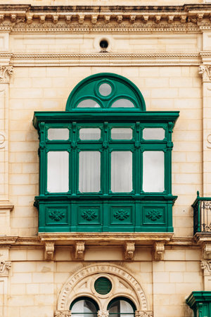 Green traditional Maltese balcony with arched window in city center of Vallettaの写真素材