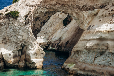 Scenic Munxar Window limestone rock arch rising above the turquoise Mediterranean Sea, Marsaskala, Maltaの写真素材