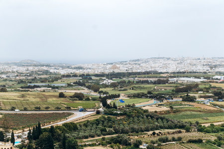 Panoramic view from the medieval city of Mdina looking towards the town of Mosta, dominated by the impressive Rotunda of Mosta.の写真素材
