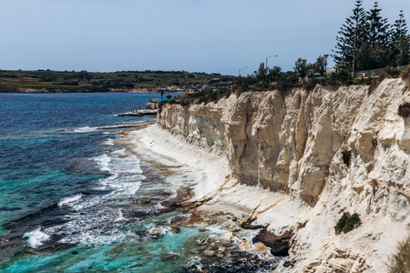 White limestone cliffs and bright turquoise Mediterranean waters along the coastline between Marsaskala and Marsaxlokk, Maltaの写真素材