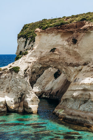 Scenic Munxar Window limestone rock arch rising above the turquoise Mediterranean Sea, Marsaskala, Maltaの写真素材