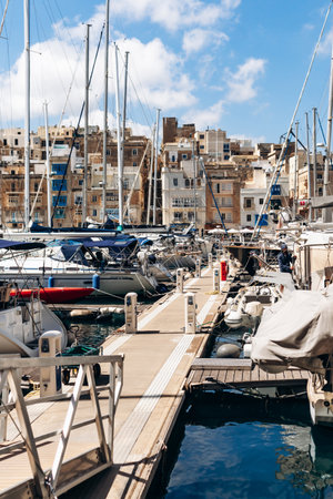 Senglea, Malta - April 10, 2025: Scenic view of traditional Maltese waterfront buildings and colorful balconies between Senglea and Birgu, with boats and yachts moored in the marina on a sunny springのeditorial素材