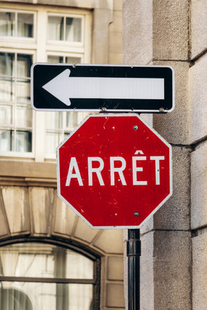 Montreal, Canada - August 11, 2025: French Arret stop sign and arrow traffic sign in historic...