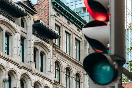 Historic building facade and red traffic light in downtown Montrealの写真素材