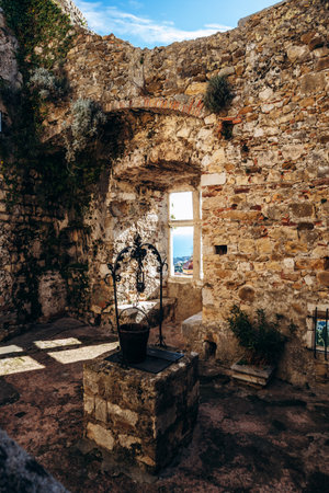 Roquebrune Cap Martin, France - February 9, 2025: Historic stone well inside the medieval Grimaldi Castle courtyardのeditorial素材