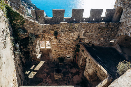 Roquebrune Cap Martin, France - February 9, 2025: Interior courtyard walls of Grimaldi Castle with stone masonry and medieval architectureのeditorial素材