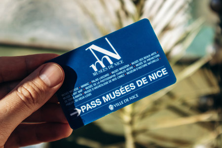Nice, France - December 9, 2025: Hand holding Nice museums pass card providing free access to city museumsのeditorial素材