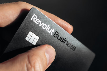 Nice, France - December 9, 2025: Male hand holding Revolut business bank card outdoorsのeditorial素材