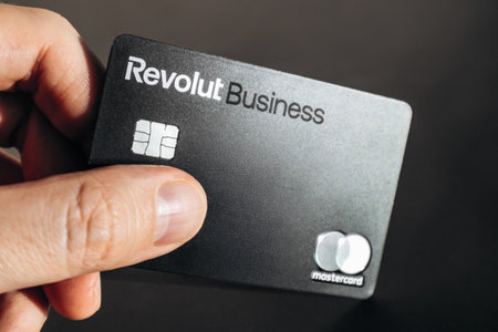 Nice, France - December 9, 2025: Male hand holding Revolut business bank card outdoorsのeditorial素材