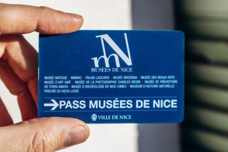 Nice, France - December 9, 2025: Hand holding Nice museums pass card providing free access to city museumsのeditorial素材
