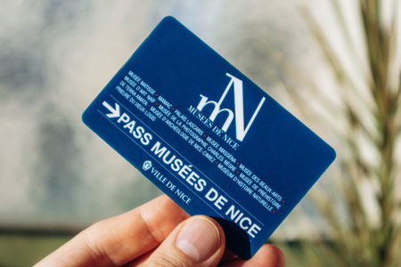 Nice, France - December 9, 2025: Hand holding Nice museums pass card providing free access to city museumsのeditorial素材