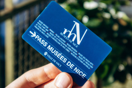Nice, France - December 9, 2025: Hand holding Nice museums pass card providing free access to city museumsのeditorial素材
