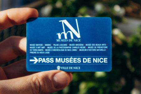 Nice, France - December 9, 2025: Hand holding Nice museums pass card providing free access to city...