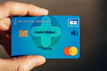 Nice, France - December 9, 2025: Close up of Avance Sante Credit Mutuel health insurance card held in male handのeditorial素材