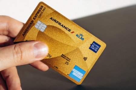 Nice, France - December 9, 2025: Man holding American Express Air France KLM Business credit card in hand, close-upのeditorial素材