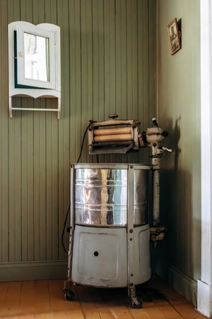 Chambord, Canada - August 18, 2025: Restored 1927 house interior with vintage manual washing machine...