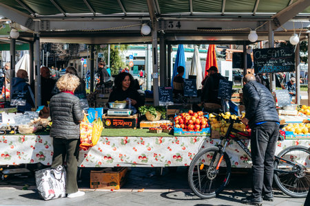Nice, France - March 23, 2025: Sunday market at Liberation district with fruit and vegetable stalls and local shoppersのeditorial素材