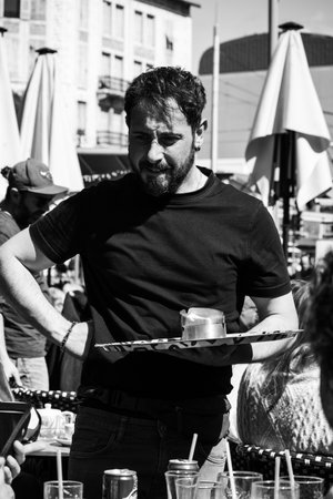 Nice, France - March 23, 2025: Waiter taking an order at an outdoor cafe at Liberation market in Niceのeditorial素材