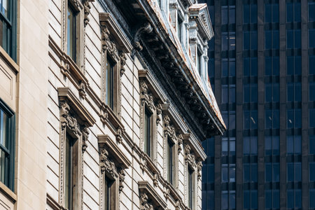 Close-up view of an ornate historic building facade in downtown Montreal with detailed stonework and...