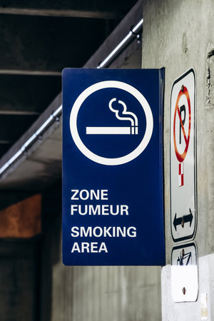 Montreal, Canada - August 15, 2025: Smoking area sign on the parking level near the car rental zone at Montreal Trudeau Airportの写真素材