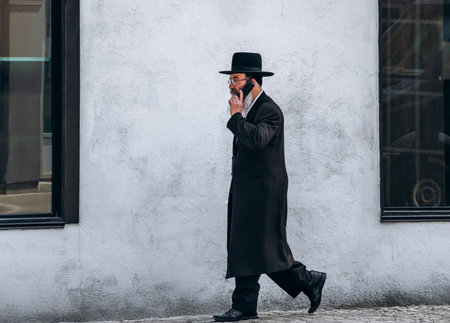 Montreal, Canada â August 12, 2025: A man in traditional orthodox Jewish clothing walking along a street in the Mile End Jewish quarter of Montreal.のeditorial素材