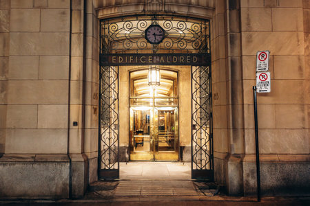 Montreal, Canada - August 13, 2025: Aldred Building (Edifice Aldred) illuminated entrance, historic...