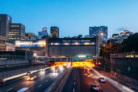 Montreal, Canada - August 13, 2025: Evening view of the Palais des congres de Montreal above the illuminated highway with downtown skyscrapers in the backgroundのeditorial素材
