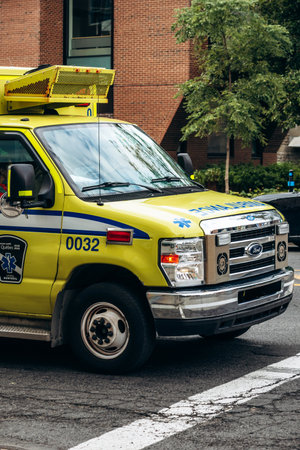 Montreal, Canada - August 13, 2025: yellow ambulance (Urgences-sante) on downtown street, Quebec...