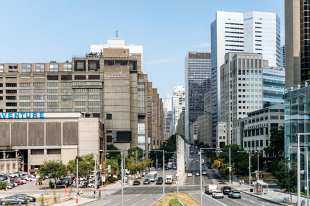 Montreal, Canada - August 14, 2025: A cityscape view of downtown Montreal with modern high-rise buildings, traffic, and urban architecture under clear summer light.のeditorial素材