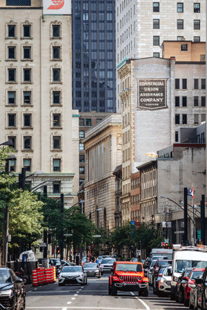 Montreal, Canada - August 14, 2025: A busy downtown street in Montreal with historic facades, modern...