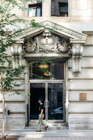 Montreal, Canada - August 14 2025: Historic stone building facade with ornate architectural details...