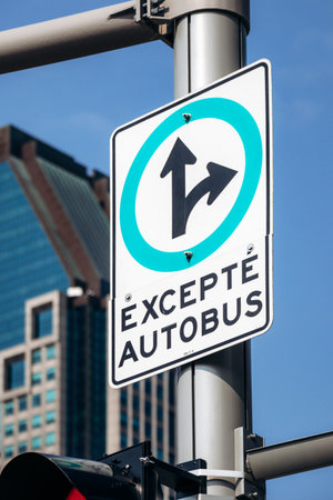 Montreal, Canada - August 14, 2025: Quebec road sign with bus travel exception, skyscraper in downtown Montreal cityのeditorial素材