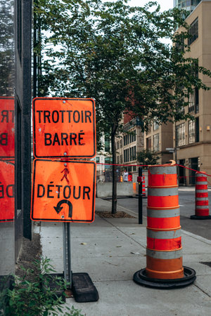 Montreal, Canada - August 14, 2025: downtown construction detour signs in French on Rue Saint-Antoine Ouestのeditorial素材