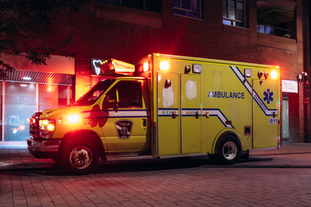 Montreal, Canada - August 15, 2025: Emergency ambulance and fire truck with flashing lights in...