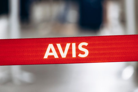 Montreal, Canada - August 15, 2025: Red Avis rental car barrier strap at Montreal Trudeau Airport