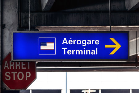 Montreal, Canada - August 15, 2025: Directional sign for the US terminal at Montreal Trudeau Airportのeditorial素材