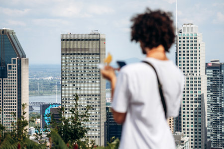 Montreal, Canada - 15 August 2025: View of downtown skyscrapers from Kondiaronk Belvedere with a person in the foregroundのeditorial素材