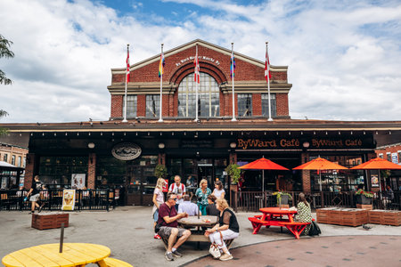 Ottawa, Canada - August 13, 2025: ByWard Market building with outdoor seating, flags, and people in central Ottawaのeditorial素材