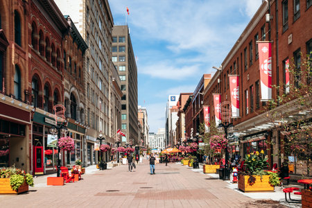 Ottawa, Canada - August 13, 2025: Pedestrian view of Sparks Street in downtown Ottawa with historic buildings, cafes, flowers, and people walking in summerのeditorial素材