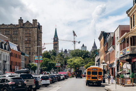 Ottawa, Canada - August 13, 2025: Central Ottawa street view with Parliament clock tower and parked carsのeditorial素材