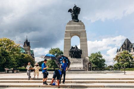 Ottawa, Canada - August 13, 2025: View of the National War Memorial in downtown Ottawa, showing visitors near the monument and a ceremonial guard standing at the post.のeditorial素材