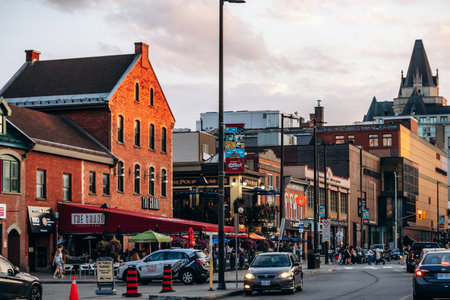 Ottawa, Canada â August 13, 2025: Evening street view in downtown Ottawa during sunset, with historic red brick buildings, restaurants, pedestrians, and traffic illuminated by warm golden light.のeditorial素材